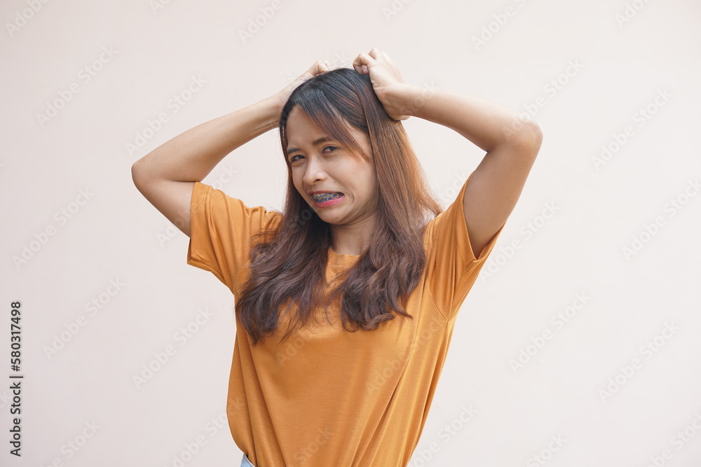Fototapeta premium Asian woman having itchy head from dandruff