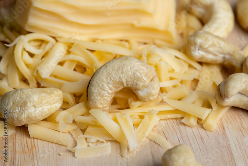 Sliced and grated hard cheese with cashew nuts