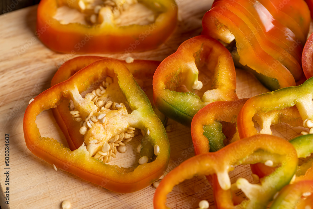 Fresh ripe bell pepper sliced on a board Fresh ripe bell pepper sliced on a board