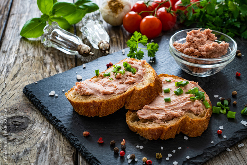 Tasty sandwiches with liverwurst and chive on wooden table
 photo