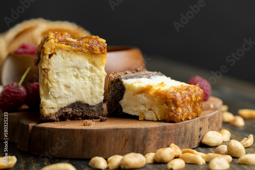 Cheesecake with chocolate sponge cake and peanuts in caramel