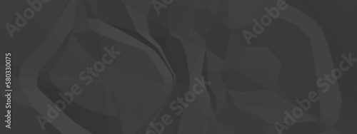 Black creased crumpled paper texture background. Black paper sheet texture.
