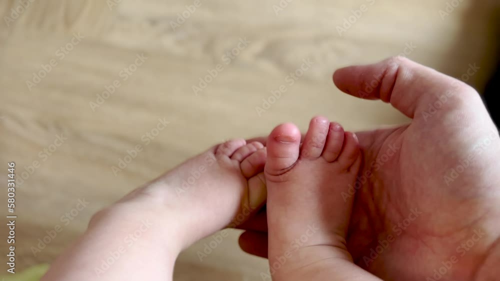 baby feet close-up captured in a cozy room. Kindergarten happy family dream concept. Baby shows her legs close-up. Funny and adorable baby foot feet close-up. Funny and charming baby lifestyle