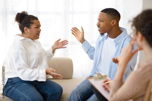Emotional furious mixed race couple figthing at therapy session