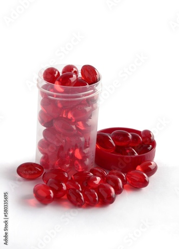 red transparent capsules as medicine against a pain