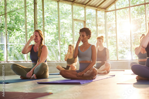 Yoga students meditating in a class photo