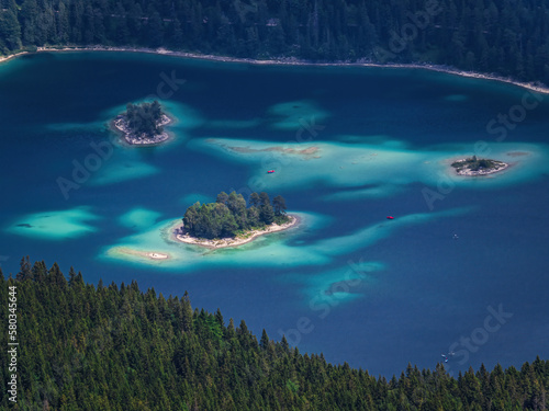 People kayaking canoeing playing water-sports on the lake sea Eibsee beach, Bavaria, Germany, aerial view