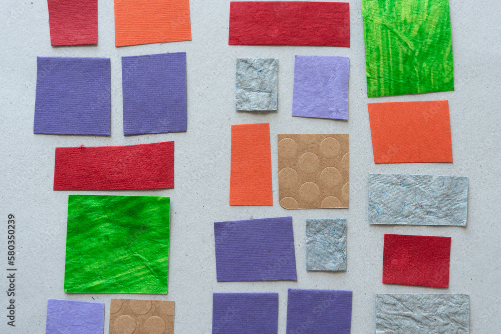 various textured paper tiles on rough gray cardboard paper