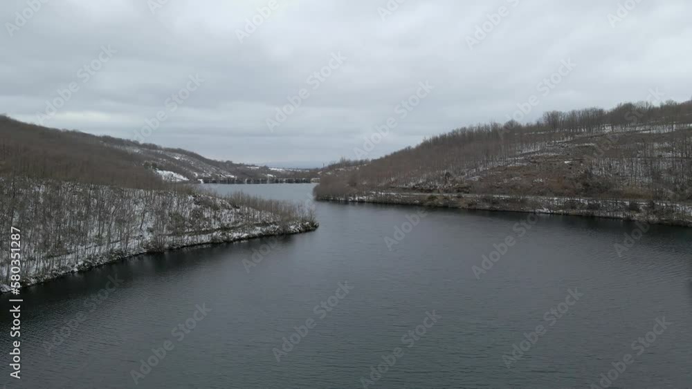 Lake between snowy mountains on a cloudy and foggy day, Somosierra, Spain, Segovia. Lake between snowy mountains on a cloudy and foggy day, Somosierra, Spain, Segovia.