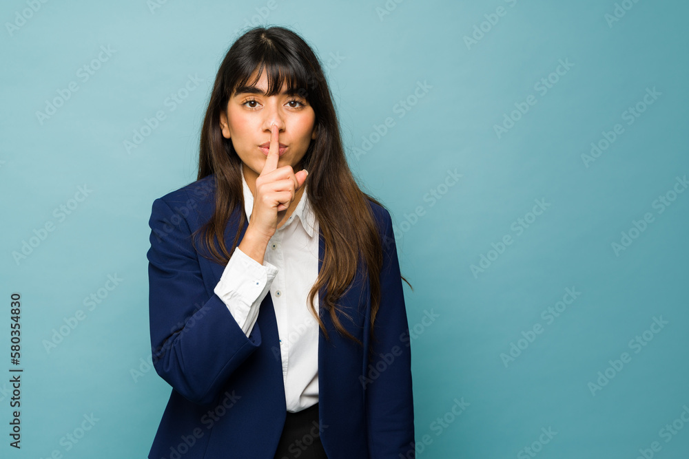 Professional woman asking to keep a work secret Professional woman asking to keep a work secret
