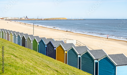 Colourful beach huts on the promenade or esplanade in the seaside town of Gorleston on the Norfolk coast photo