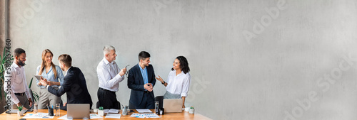 Coworkers Communicating Standing During Business Meeting In Modern Office, Banner