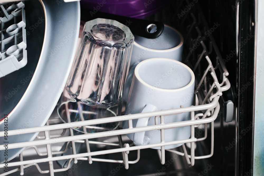 Inside dishwasher view. Washing dishes background. Full shelf with load of glassware. Home utensils cleaning. Kitchen background. Dish wash background. Saving water method. Eco housework. Inside dishwasher view. Washing dishes background. Full shelf with load of glassware. Home utensils cleaning. Kitchen background. Dish wash background. Saving water method. Eco housework.