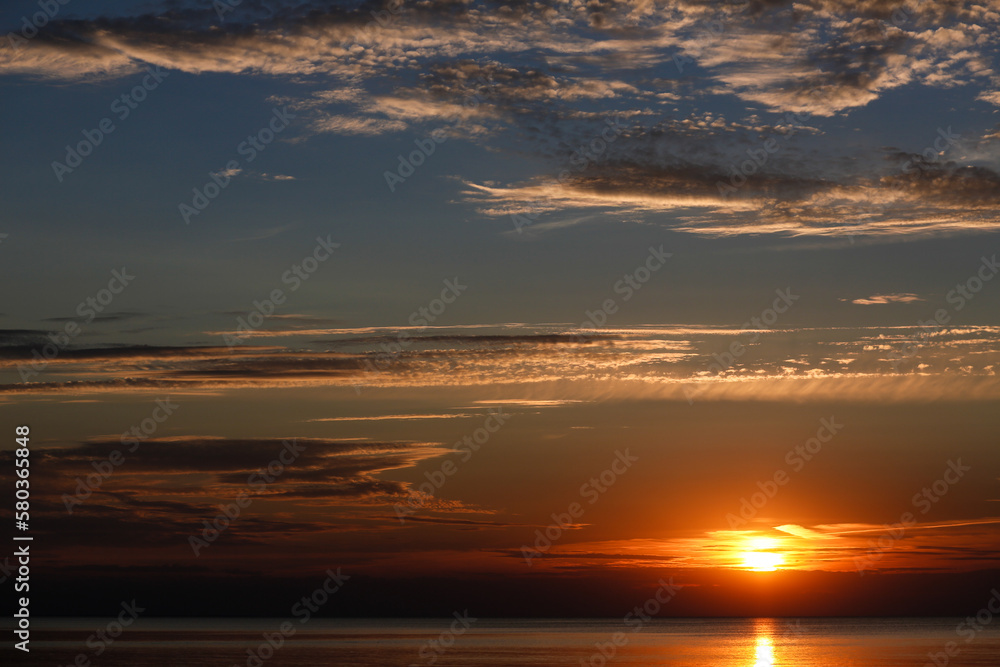 Sunset over calm ocean water surface