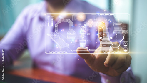 Businessman pointing at hologram with icon on virtual screen, Smart factory technology interface