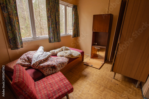 Abandoned camping cabin in a remote area on a cloudy day. Spring.