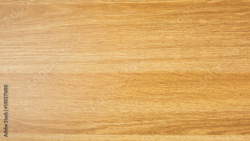 Background of a laminated panel imitating an old wooden board in dark yellow color