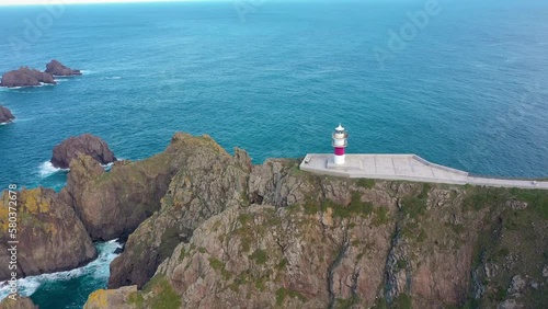 Aerial drone point of view of Ortegal Cape Lighthouse. Historical location in North of Spain - Galicia. Is the true starting point where the Atlantic Ocean and the Cantabrian Sea join. Drone spinning  photo