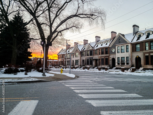Sunset in the winter in downtown Birmingham, Michigan with townhomes in the foreground