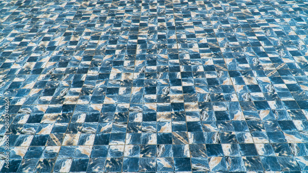 Fototapeta premium Marble tile floor with sea wave water design pattern. Marble tile floor with blue checkered pattern.