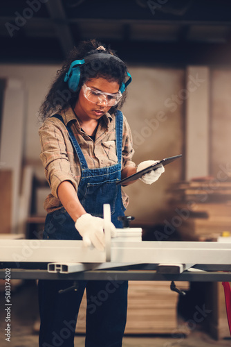African american woman craftgirl working in handmade DIY workwood workshop, Small business owner in furniture industry.