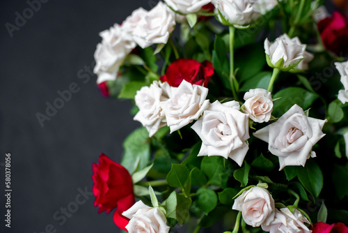 Fototapeta Naklejka Na Ścianę i Meble -  bouquet of red and white roses on a stone background with copy space for your text
