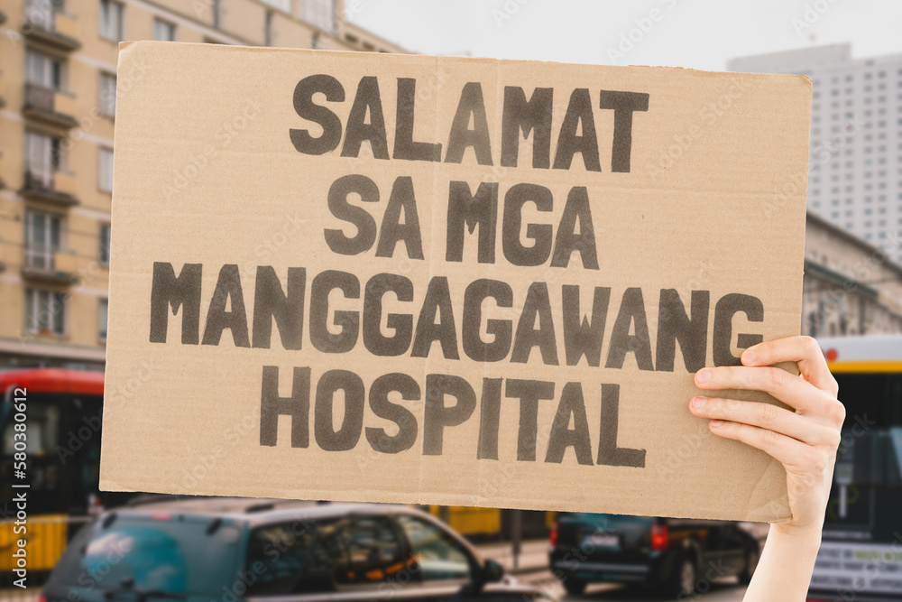 The phrase " Thank you hospital workers " on a banner in hand. The