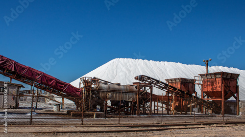 Salt refinery plant in the USA. Pile of salt and equipment.