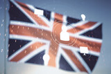 Double exposure of social network icons hologram on flag of Great Britain and blue sky background. Networking concept