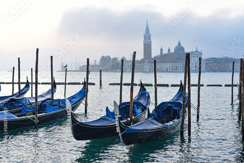 Venice, Italy - 15 Nov, 2022: Morning views of gondolas, the Grand Canal, and San Giorgio Bell Tower