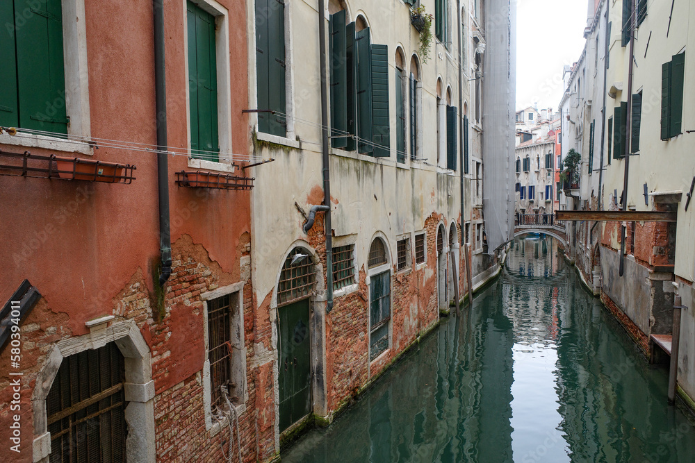 Venice, Italy - 14 Nov, 2022: Colourful backstreet canals of the Venetian Lagoon