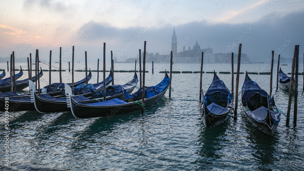 Venice, Italy - 15 Nov,  2022: Morning views of gondolas, the Grand Canal, and San Giorgio Bell Tower