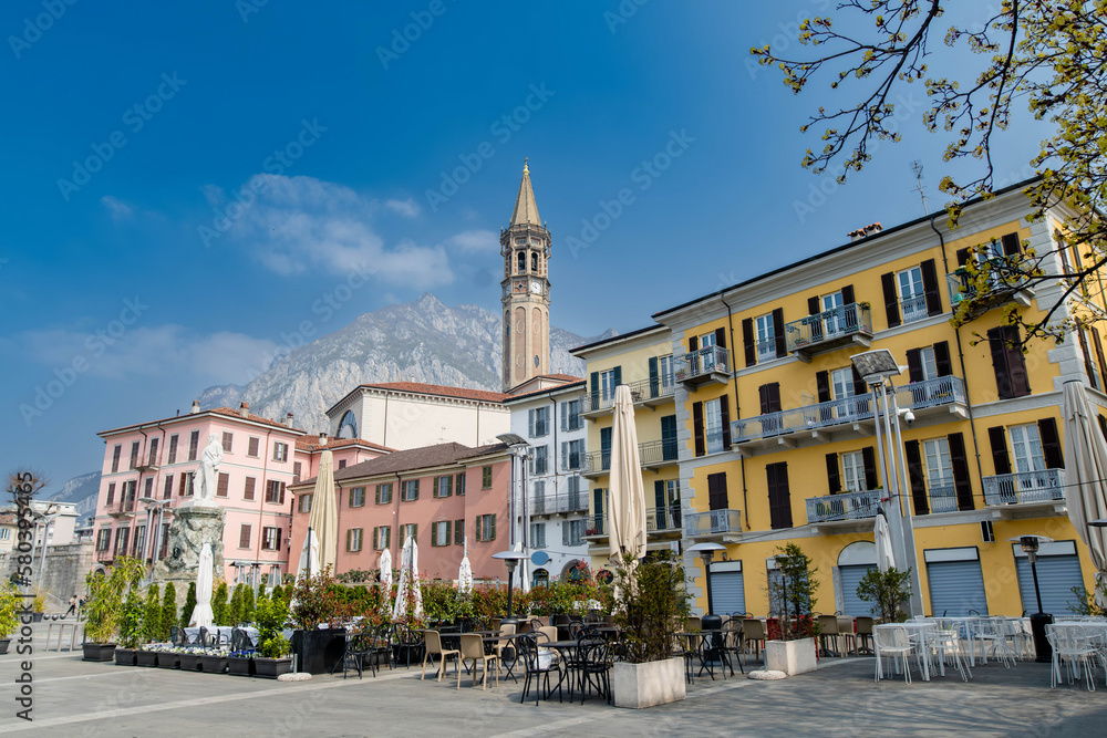 Mario Cermenati square of Lecco town, situated nearby to the memorial Monument of Mario Cermenati and the church Minor Basilica of San Nicolo. Spring morning in Lecco, Lombardy, Italy.