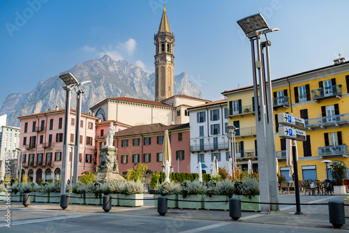 Mario Cermenati square of Lecco town, situated nearby to the memorial Monument of Mario Cermenati and the church Minor Basilica of San Nicolo. Spring morning in Lecco, Lombardy, Italy.