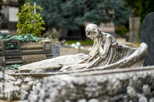 Impressive sculptures on the tombs and monuments of Cimitero Monumentale di Milano or Monumental Cemetery of Milan. Milan, Italy. photo