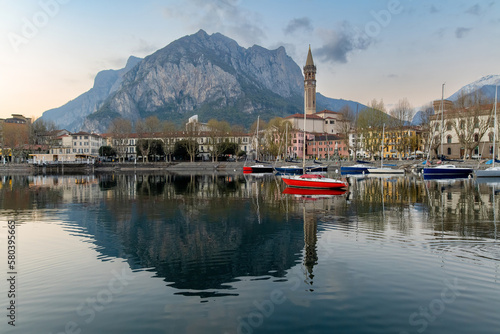 Sunny cityscape of Lecco town on spring day. Picturesque waterfront of Lecco town located between famous Lake Como and scenic Bergamo Alps mountains.