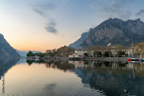 Sunny cityscape of Lecco town on spring day. Picturesque waterfront of Lecco town located between famous Lake Como and scenic Bergamo Alps mountains.