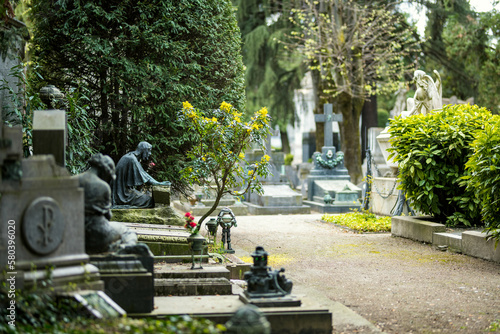 Impressive sculptures on the tombs and monuments of Cimitero Monumentale di Milano or Monumental Cemetery of Milan. Milan, Italy. photo