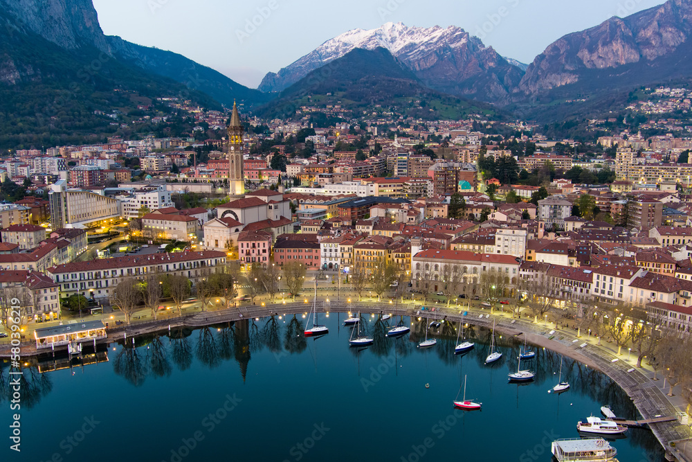 Stunning aerial cityscape of Lecco town on spring evening. Picturesque waterfront of Lecco town located between famous Lake Como and scenic Bergamo Alps mountains.