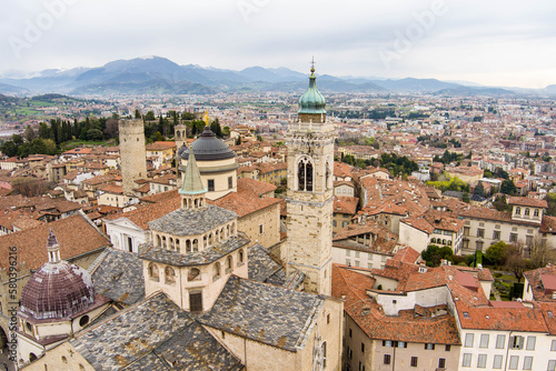 Scenic aerial view of Bergamo city. Flying over Citta Alta, town's upper district, known by cobblestone streets and encircled by Venetian walls. Bergamo, Lombardy, Italy.