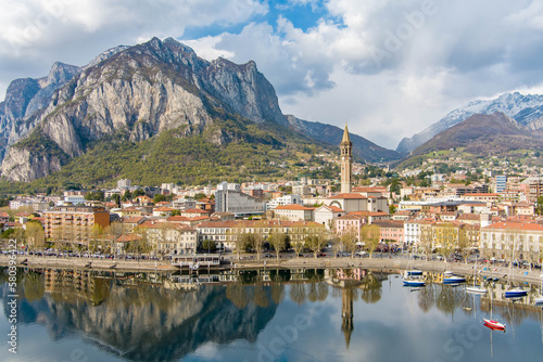 Sunny aerial cityscape of Lecco town on spring day. Picturesque waterfront of Lecco town located between famous Lake Como and scenic Bergamo Alps mountains. photo