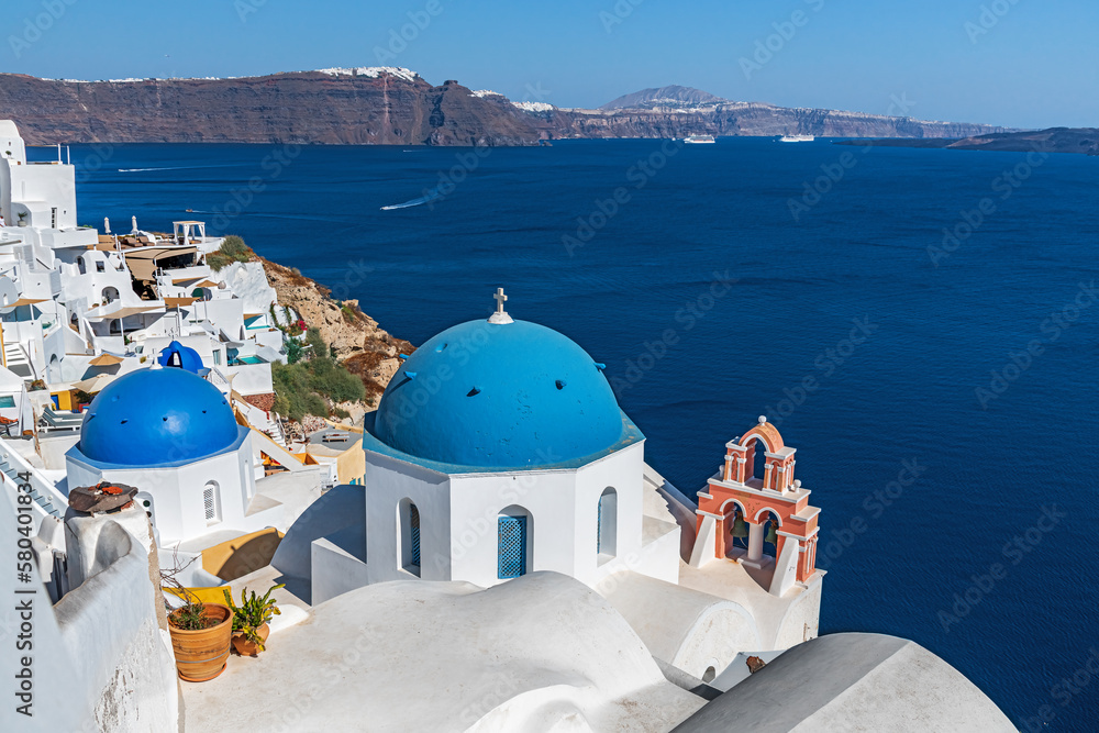 Fototapeta premium Blue domes and orange bell tower on the island of Santorini. Greece.