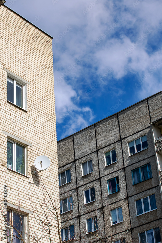 Fototapeta premium Tall apartment buildings on blue sky nof with clouds