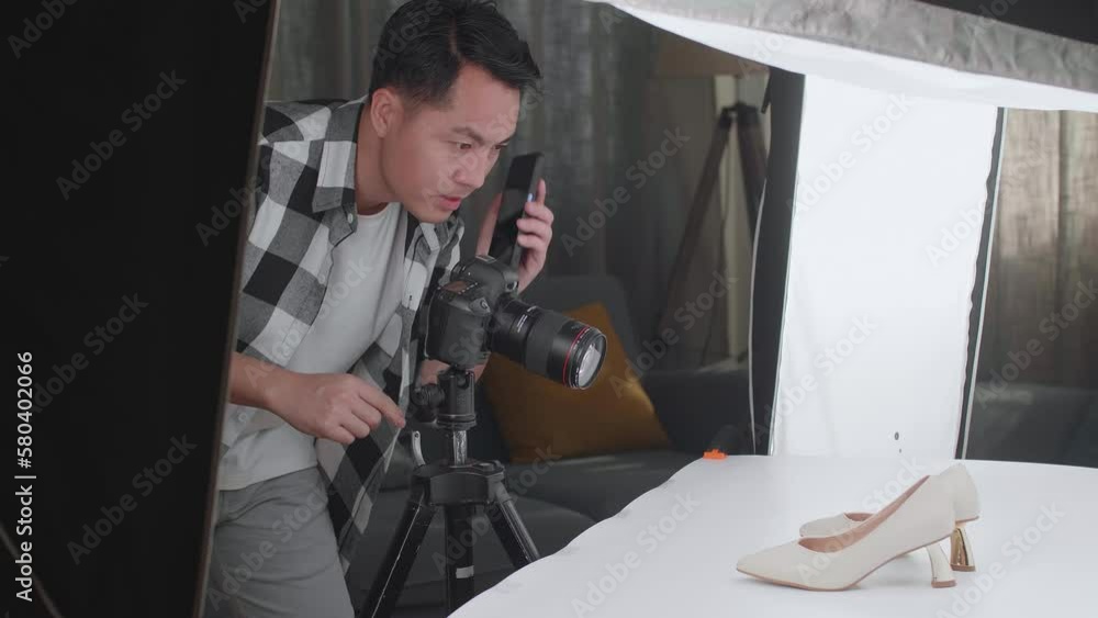 Asian Male Photographer Talking On Smartphone While Taking Photos Of Women'S Shoes In Home Studio
Asian Male Photographer Talking On Smartphone While Taking Photos Of Women'S Shoes In Home Studio