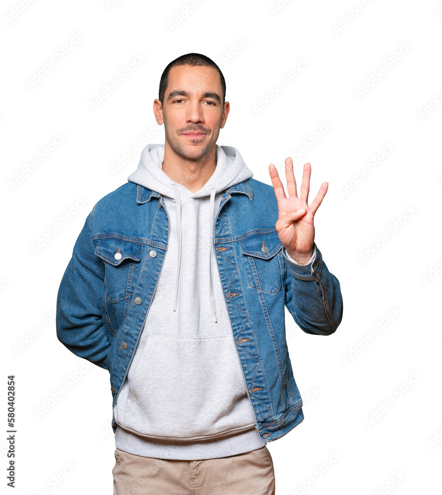 Young man making a number four gesture Young man making a number four gesture