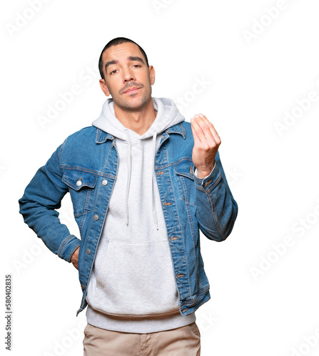 Confused young man making an italian gesture of not understanding photo