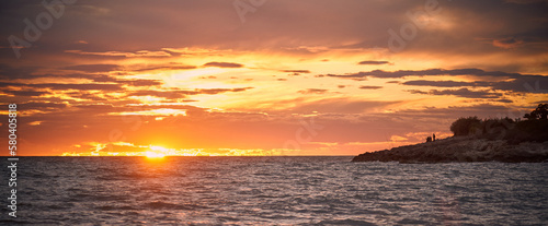 cloudy sky with sunset  sea and fishermen