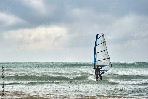 winsurfing athlete sailing in the sea