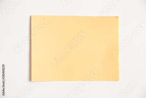 Yellow paper card isolated on white background close up