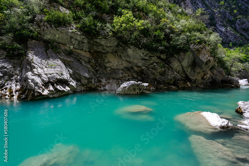 Turquoise light blue lagoon mountain river water making it transparrent